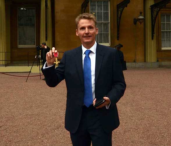 Martin Collins with his OBE following the investiture at Buckingham Palace