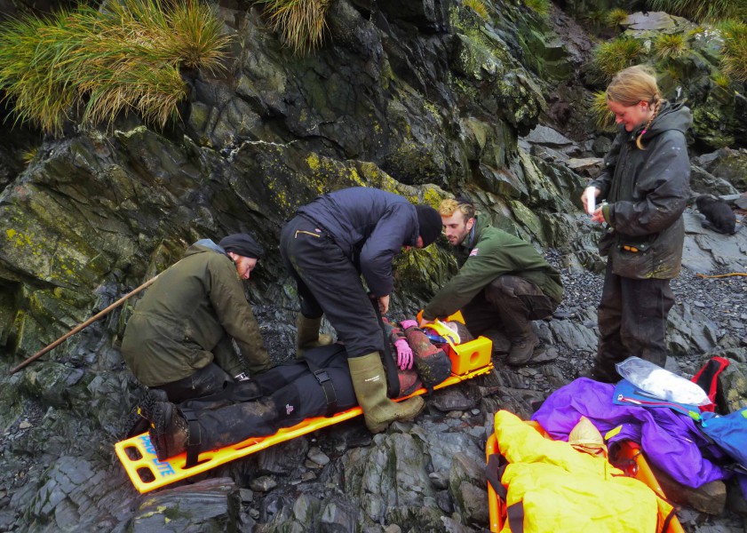 Search and Rescue: making sure the casualty is secure in the spinal board before attaching an oxygen mask and transferring her to the stretcher